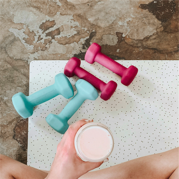 a women drinking coffee after exercise
